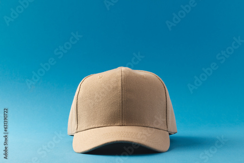 Cream baseball cap and copy space on blue background