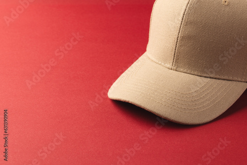 Cream baseball cap and copy space on red background