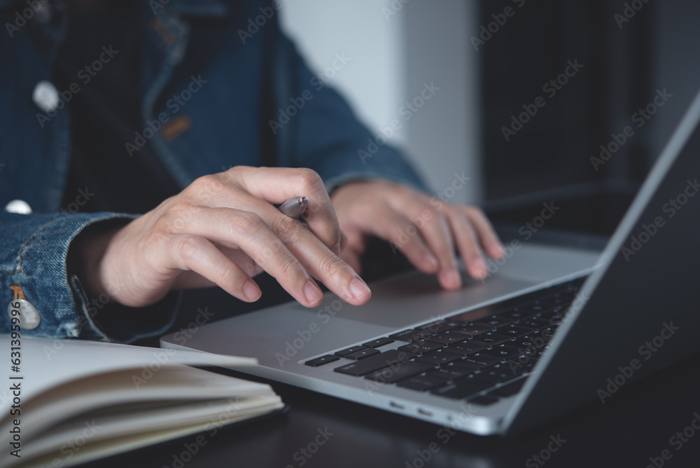Business planning, E learning concept. Business woman working on laptop computer and planning work on paper notebook at office. Woman searching data on internet, studying online via laptop Business planning, E learning concept. Business woman working on laptop computer and planning work on paper notebook at office. Woman searching data on internet, studying online via laptop