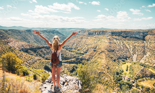 Woman standing on cliff enjoying beautiful panoramic canyon landscape- hiking, adventure, travel concept © M.studio