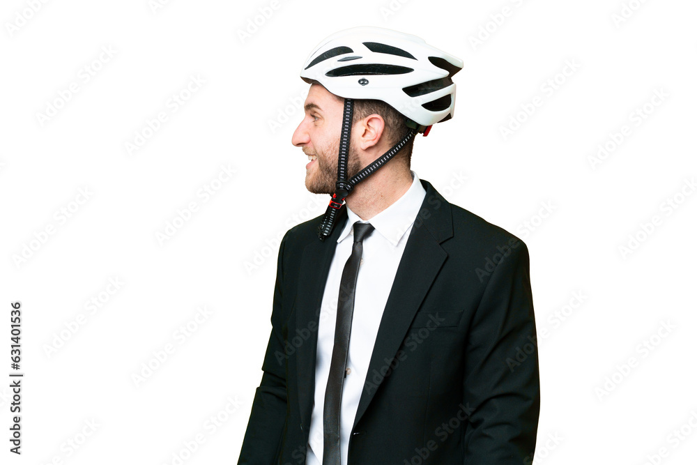 Business person with a bike helmet over isolated chroma key background laughing in lateral position Business person with a bike helmet over isolated chroma key background laughing in lateral position