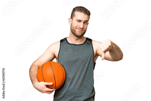 Handsome young man playing basketball over isolated chroma key background showing thumb down with negative expression © luismolinero