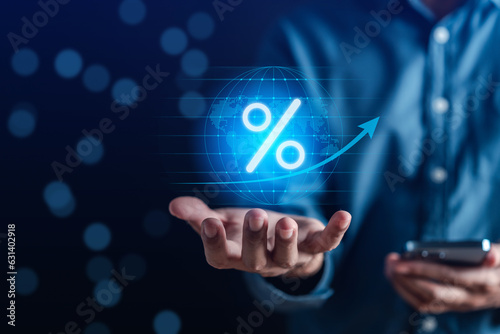 Business hand holding percentage symbol with world virtual, global financial banking increase interest rate concept. dividend and capital gain world of money investment.