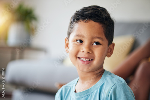 Kid, smile and happy in family home in the morning with thinking feeling relax in living room. Lens flare, face and house with young child, boy and cute son from Brazil on weekend with joy and youth