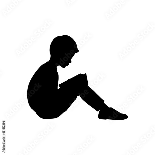 Silhouette of a boy reading a book.