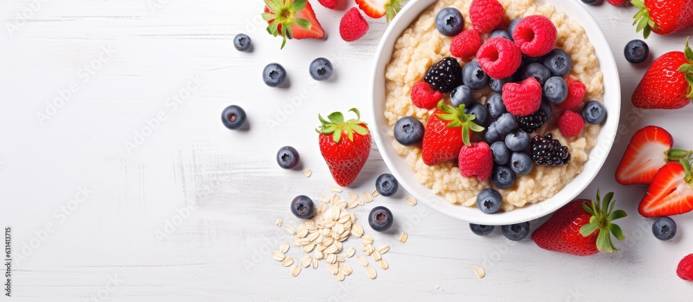 A healthy breakfast of oatmeal topped with berries and fruits is shown on a light background. taken A healthy breakfast of oatmeal topped with berries and fruits is shown on a light background. taken