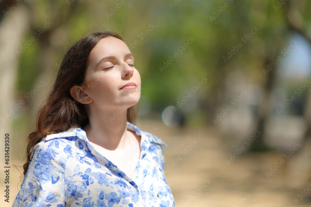 Woman breathing fresh air a sunny day in nature Woman breathing fresh air a sunny day in nature