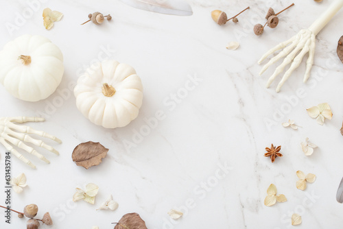 white halloween pumpkins with decor on marble background © Maya Kruchancova