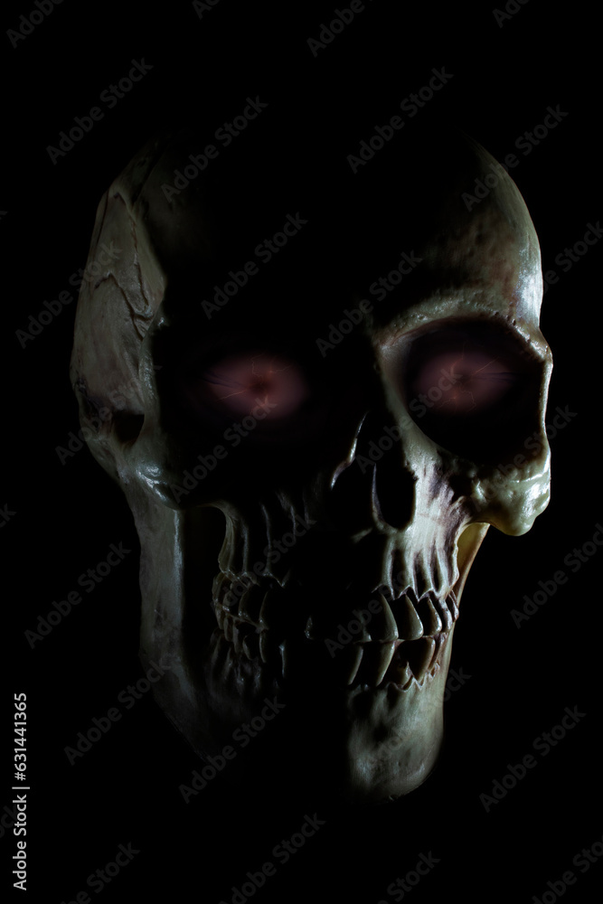 Naklejka premium Scary human skull with purple eyes