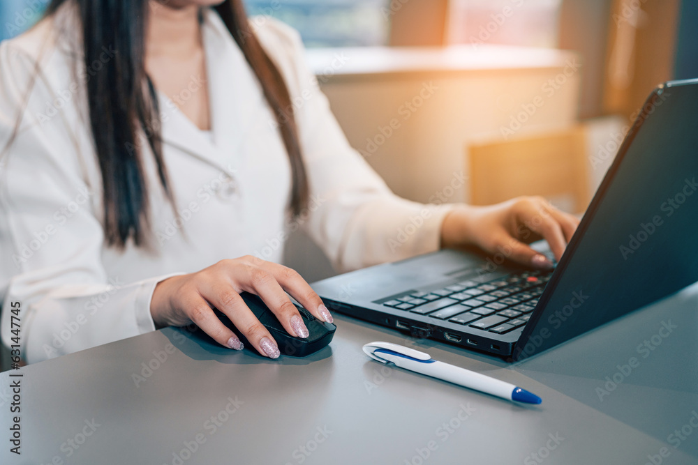 Closeup hand businesswoman professional working with laptop on their desks in the office. Closeup hand businesswoman professional working with laptop on their desks in the office.