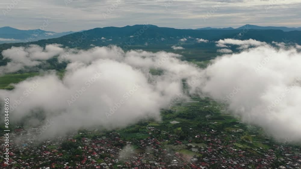 Aerial drone of valley with tea plantations and farmland with clouds. Kayu Aro, Sumatra, Indonesia. Tea estate landscape. Aerial drone of valley with tea plantations and farmland with clouds. Kayu Aro, Sumatra, Indonesia. Tea estate landscape.