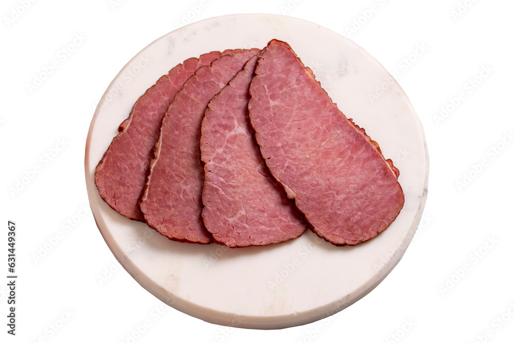 Beef jerky pieces isolated on white background. Sliced pieces of dry meat on a stone floor. close up Beef jerky pieces isolated on white background. Sliced pieces of dry meat on a stone floor. close up