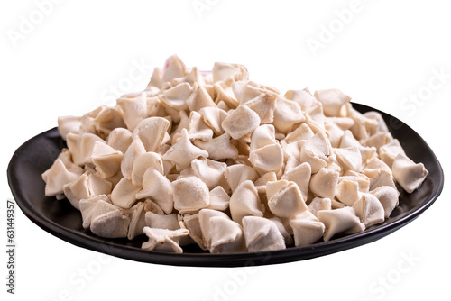 Frozen ravioli isolated on white background. Stuffed ravioli in the middle. Turkish ravioli. Traditional world cuisine delicacies. Close-up.