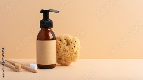Brown glass bottle with a sea sponge on a yellow background