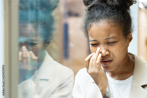 allergic sick African woman having sinus pain, runny nose, cold flu or covid-19 infection, health care and allergy concept image