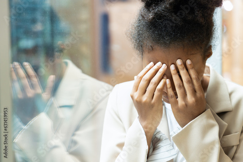 Stressful overworked and sick african woman doint facepalm gesture photo