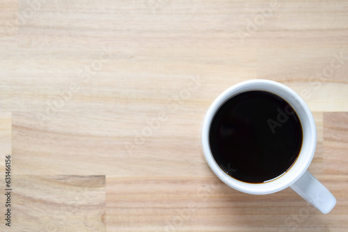 A cup of coffee on a blurred wooden background