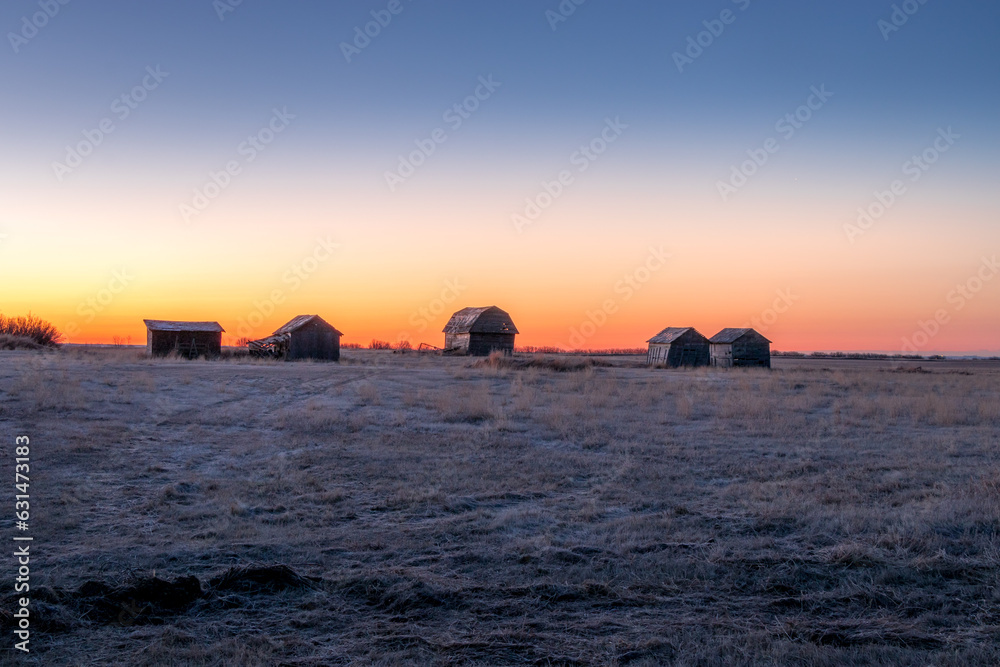 Fototapeta premium Sunrise over rustic farm buildings Keoma Alberta Canada