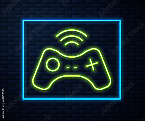 Glowing neon line Wireless gamepad icon isolated on brick wall background. Game controller. Vector