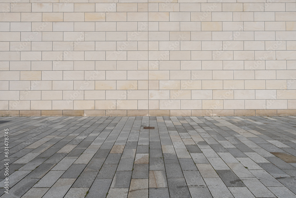 texture of a tiled beige stone wall an paved floor as background