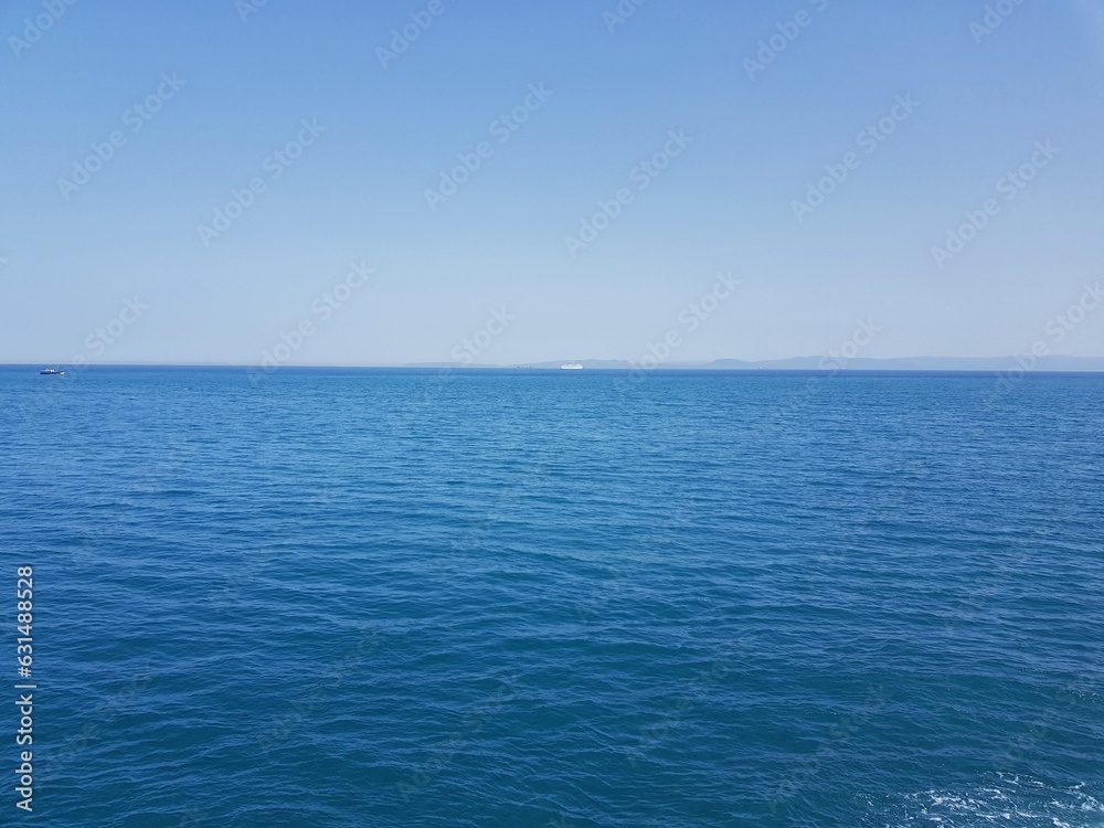 The front view in the morning sky is bright blue with clear white clouds. And the deep indigo of the ocean in broad daylight feeling calm, fresh, relaxing. Gibraltar from Belyounech city in Morocco.