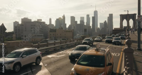 cars driving on brooklyn bridge at golden hour