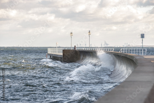 Gdynia Seaside Boulevard During a Storm. Water Splashing Against the Breakwater.