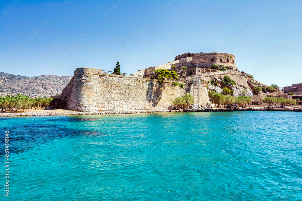 Panoramic view of the island of Spinalonga with calm sea.