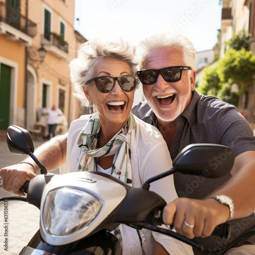 Retired couple on a scooter, happy seniors on vacation