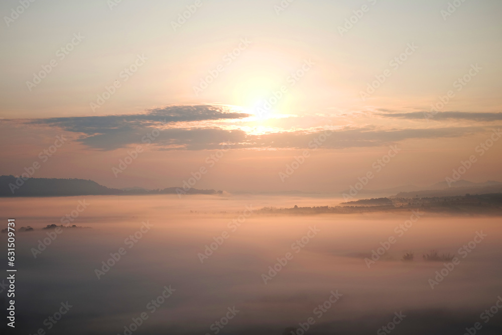 Beautiful Sunset and sunrise on sky and golden twilight time with mist and fog in valley of layer mountain