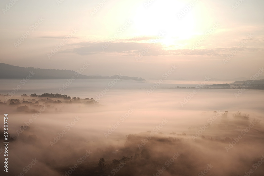 Beautiful Sunset and sunrise on sky and golden twilight time with mist and fog in valley of layer mountain