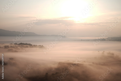 Beautiful Sunset and sunrise on sky and golden twilight time with mist and fog in valley of layer mountain