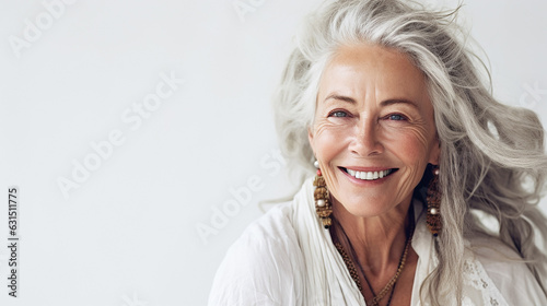 Portrait of a smiling woman in her 70s on a white background. Lifestyle. © Vanessa GF