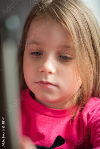 Portrait of a beautiful little girl in a cafe.