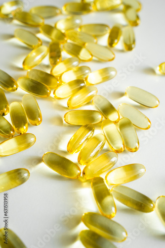 Gelatin capsules of omega 3, 6, 9 fish oil, vitamin isolated on a white surface as a background. © Volodymyr