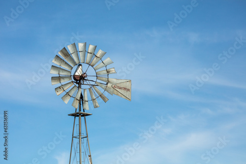 Scenic view of an old-fashioned windmill against a blue sky