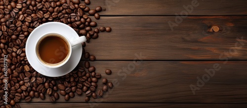 The top view of a coffee cup and beans on an old kitchen table, with room for your text.