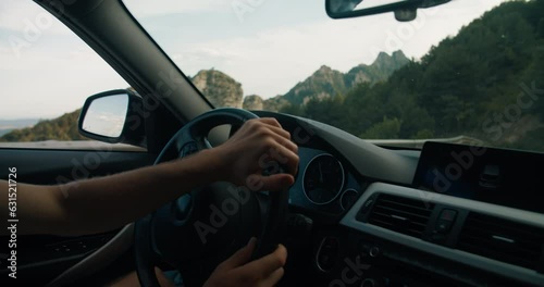 Man driving a car on mountain adventure slow motion handheld shot