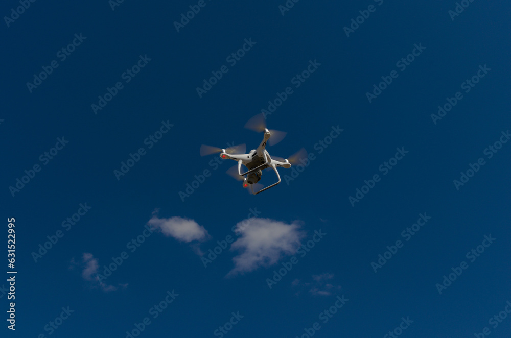Quadcopter in a blue and clear sky on its way to 