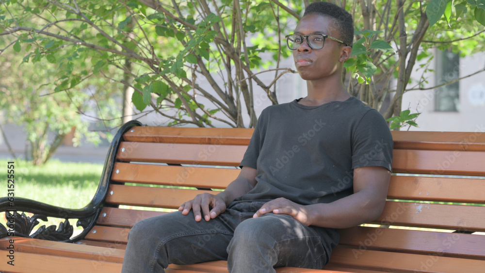 Serious Young African Man Sitting Outdoor Serious Young African Man Sitting Outdoor