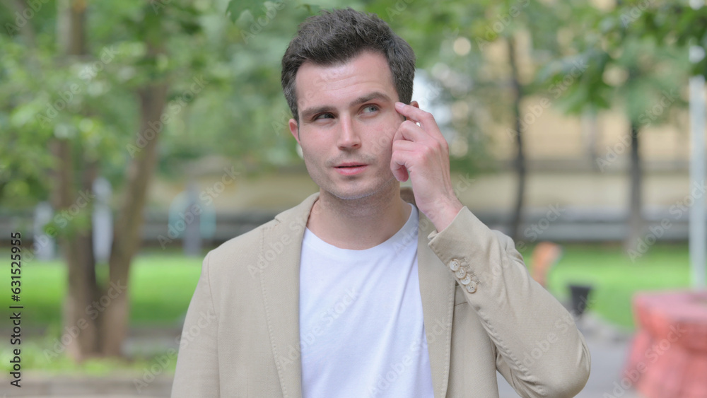 Outdoor Portrait of Brainstorming Casual Young Man with an Idea Outdoor Portrait of Brainstorming Casual Young Man with an Idea