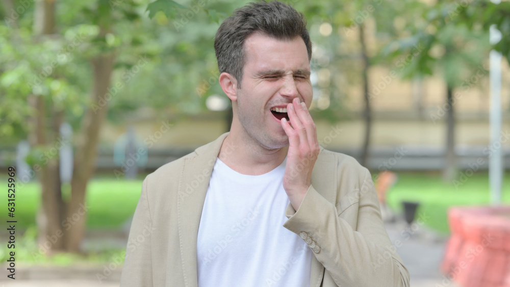 Outdoor Portrait of Yawning Casual Young Man Outdoor Portrait of Yawning Casual Young Man
