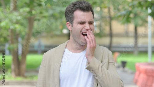 Outdoor Portrait of Yawning Casual Young Man