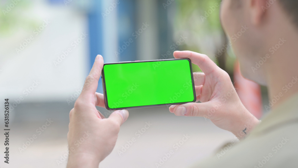 Young Man Holding Phone with Green Screen Outdoor Young Man Holding Phone with Green Screen Outdoor