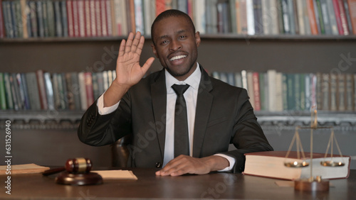 African Male Lawyer Waving Hand to Say Hello in Office