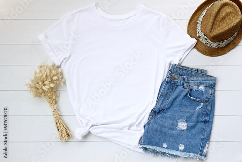 White women’s T-shirt mockup with jean and clothing accessories. Blank white t-shirt, t shirt front isolated wood background, boho design. closeup white t shirt