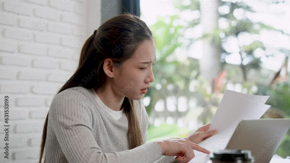 Pretty Asian woman stressed with checking account of small coffee shop and overspending. Make sure it matches the laptop computer page file. in order to manage the store management without loss Pretty Asian woman stressed with checking account of small coffee shop and overspending. Make sure it matches the laptop computer page file. in order to manage the store management without loss