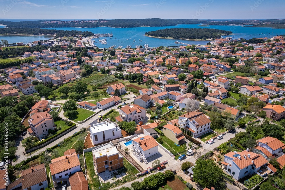Aerial view of residential houses near the sea on a sunny day in Medulin, Croatia