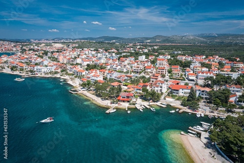 Aerial view of an idyllic coastal scene featuring a tranquil blue ocean and bright white buildings photo