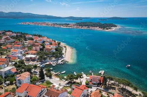 Aerial view of an idyllic coastal scene featuring a tranquil blue ocean and bright white buildings